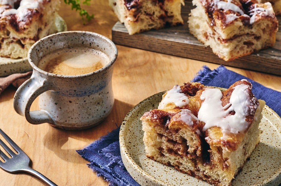Cinnamon Roll Focaccia on a plate with a cup of coffee - select to zoom